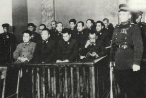 Black and white photograph of defendants at trial post World War II.