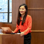 Diana Fu stands at podium in Munk School