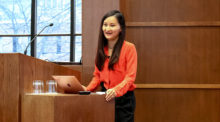 Diana Fu stands at podium in Munk School