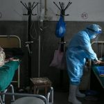 A nurse treats a patient inside a COVID-19 ward of a government run hospital in Kathmandu, Nepal on May 12, 2021. (AP Photo/Niranjan Shrestha)