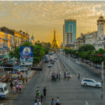 streetscape in Southeast Asia with golden pagoda in background