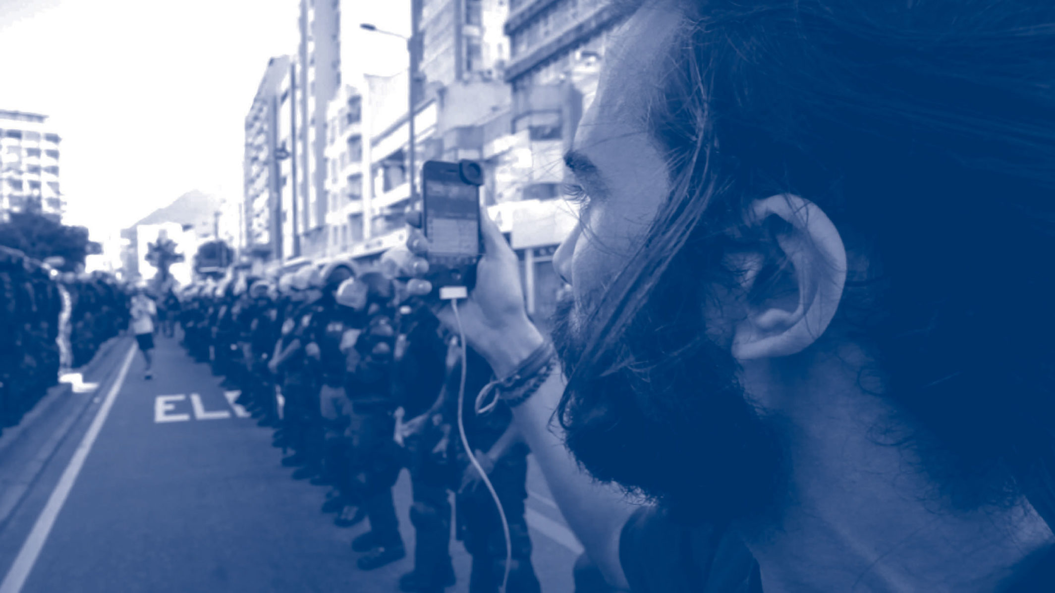 A man photographing a protest.