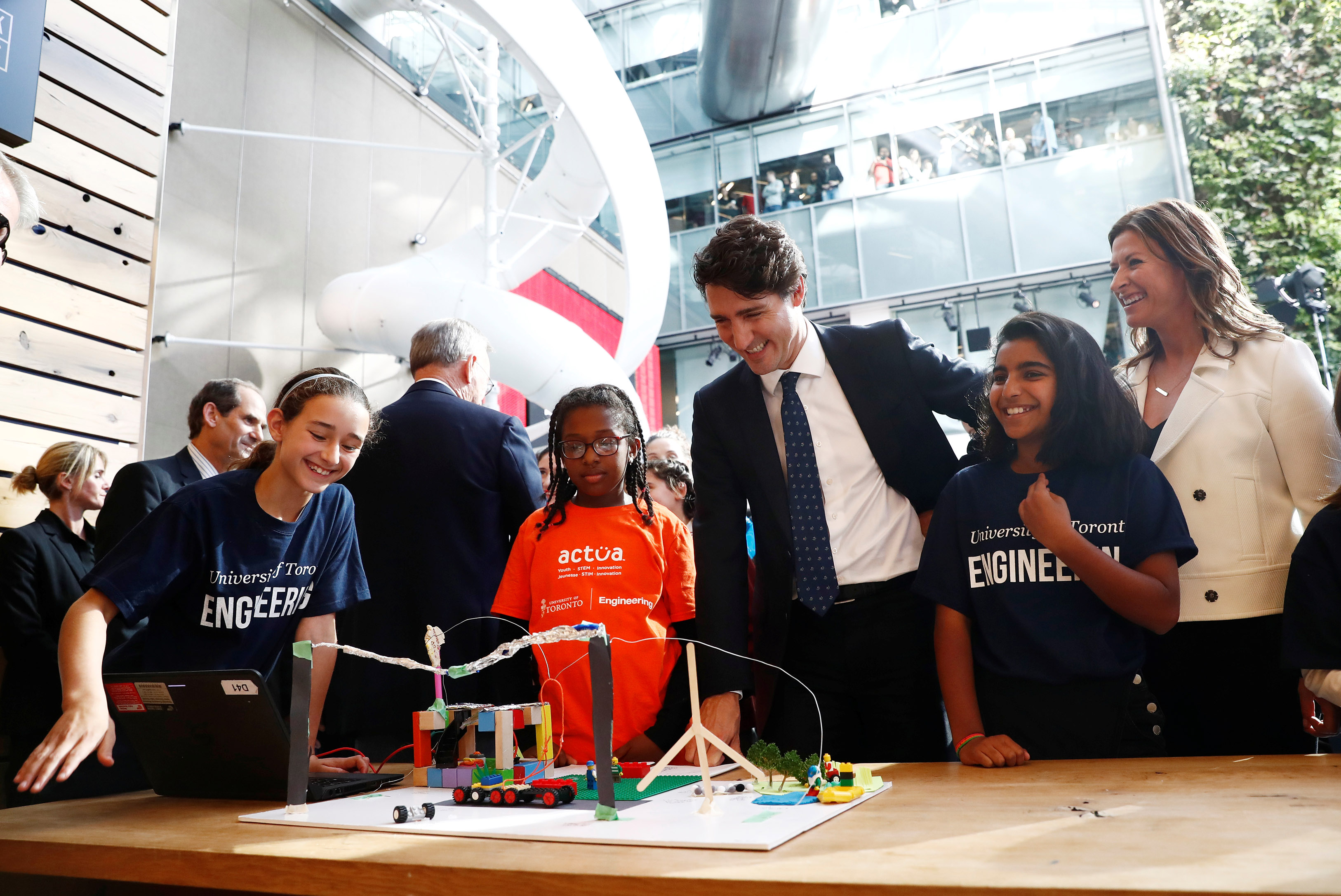 Prime Minister Justin Trudeau and children attend press conference.