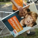 This is an image of a German political activist carrying an election poster in preparation for German elections on September 22, 2013