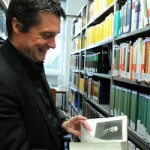Picture of Rainer Forst standing in a library between book shelves