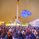 a Photo of a crowd on the Independence Square in Kiev including people waving flags of EU and Ukraine