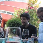 Karolina Dejnincka, Samuel Baird, and Peter Prazic talking over a glass of wine