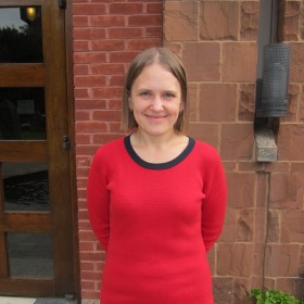 Photo of Olga Kesarchuk standing in Munk School courtyard