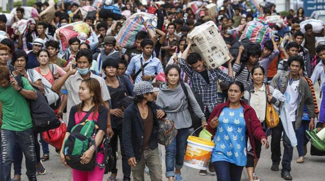 Crowd of people in the street in Southeast Asia, many carrying bags