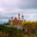 Colourful castle and trees on a cloudy day