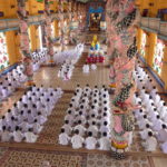 Colourful temple room with worshippers