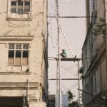 Man on scaffolding between two buildings