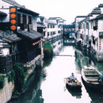 Chinese canal with two boats and houses