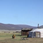 Woman sitting outside a yurt in daytime