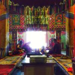 Monks sitting in a colourful room