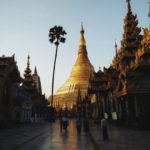 A golden Buddhist pagoda and other buildings