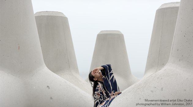 Movement-based artist Eiko Otake poses among concrete tetrapods.