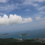 Hainan, China, photo of clouds above land and sea on the coast.