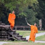 Monks take selfies at Angkor Wat.