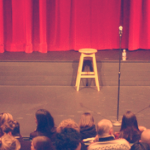 Stool and microphone on empty stage