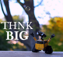Image: 'Think Big' text with gleeful robot