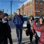 Munk One students listen to anthropologist Emily during their ethnography in Kensington Market.