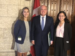 Munk one student stands with MP Erin O'Toole and other UofT student Cindy Wu in front the chamber of commons in Parliament