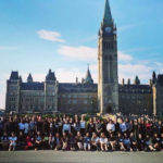 A group photo of the 2017 Women in House cohort in front of the Parliament Buildings in Ottawa.