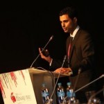 Elad Dvash-Banks at a podium presenting