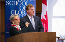 Picture of Janice Stein and John Baird standing nearby a podium
