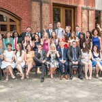 Director Stephen Toope stands outdoors with a group of graduating students from the Master of Global Affairs program.