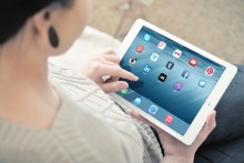 A young woman uses an ipad.