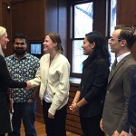 Catherine McKenna shakes hands with students