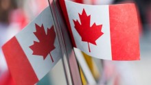 A small Canadian flag against a mirror