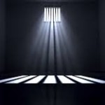 A dark, empty prison cell