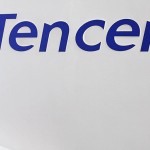 Girl on phone in front of Tencent logo