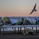 A tribute of flowers is laid on a bench in Nice, France