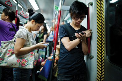 people using mobile devices on while commuting