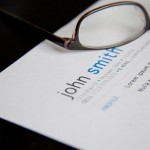 A pair of glasses sits on top of a resume