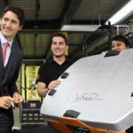 Prime Minister Justin Trudeau signs a robotic unit during a tour of the Amazon Fulfillment Centre in Brampton.