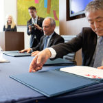 Yasunori Nakayama and Meric Gertler sign agreement at announcement ceremony.