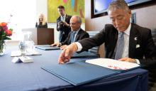 Yasunori Nakayama and Meric Gertler sign agreement at announcement ceremony.