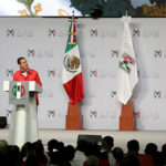 President Enrique Pena Nieto giving a speech at a podium.