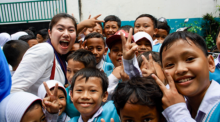 Kana Shishikura poses with students from an Indonesian boarding school.
