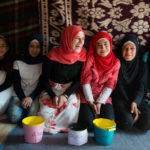Syrian refugee girls gather in a settlement in Lebanon