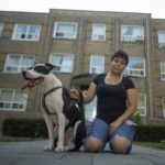 Gabriela Martinez, a Toronto resident, poses in front of her apartment building with her dog.
