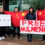 Protesters in China hold up signs calling for the release of Huawei executive Meng Wanzhou