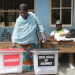 A woman casts her votes during the gubernatorial and state house assembly elections at a polling center in Makoko near Lagos