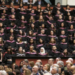 Group of graduates sit in convocation hall