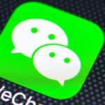 The WeChat icon appears on a cell phone screen